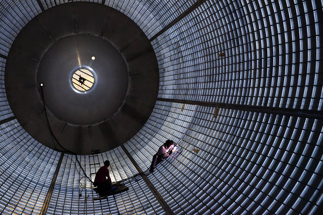 Welders work inside a massive Space Launch System fuel tank at NASA’s Michoud Assembly Facility in New Orleans.