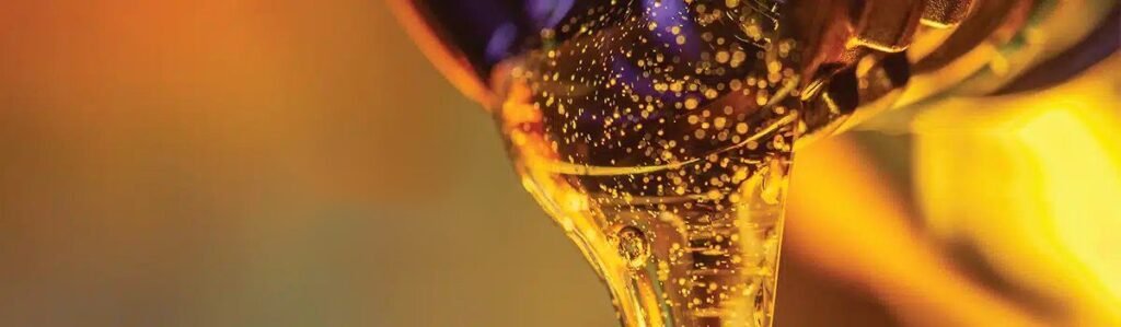 Golden engine oil pouring from a bottle